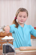 Child weighing flour on a scale