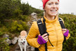Photo: Happy woman hiking in mountains with akita dog, Poland Happy woman hiking in mountains with akita dog, Poland