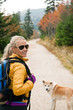 Woman hiking in mountains with akita dog