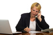Mature businesswoman calling on the phone at her workplace.