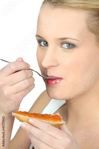 Photo: Woman eating bread and jam Woman eating bread and jam