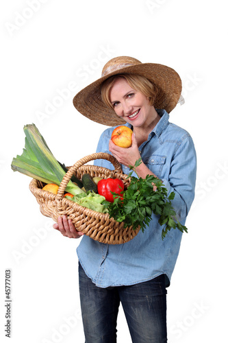 Photo: Woman with basket of vegetables Woman with basket of vegetables