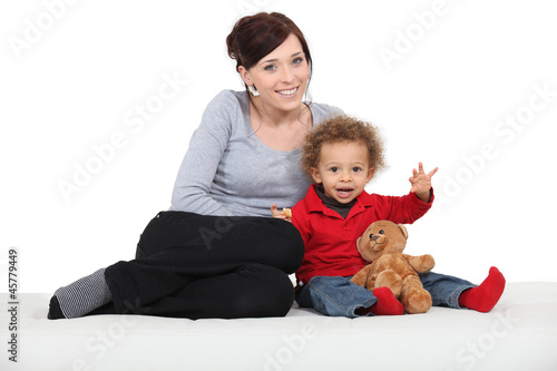Photo: Mother sat with little boy and toy bear Mother sat with little boy and toy bear