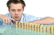 Young man with a row of dominoes