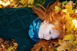 Beautiful woman lying on fall leaves