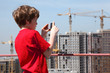 boy with camera photo construction yard from roof of building