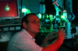Photo: Scientist demonstrate laser of microparticles in lighting lab Scientist demonstrate laser of microparticles in lighting lab