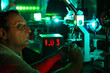 Photo: Scientist with glass demonstrate laser of microparticles Scientist with glass demonstrate laser of microparticles