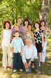 Big family of eight people pose at park
