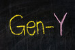  The word GEN-Y handwritten with chalk  on a blackboard
