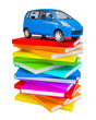 Blue family car on a stack of colorful books