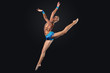 Young woman in gymnast suit posing