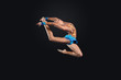 Young woman in gymnast suit posing