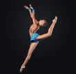 Young woman in gymnast suit posing