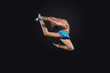 Young woman in gymnast suit posing