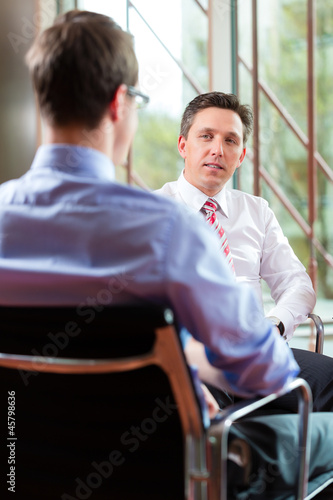 Photo: Business - young man and CEO in job interview Business - young man and CEO in job interview