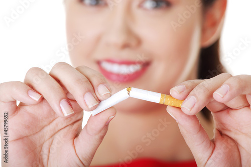 Photo: Young woman with broken cigarette. Young woman with broken cigarette.