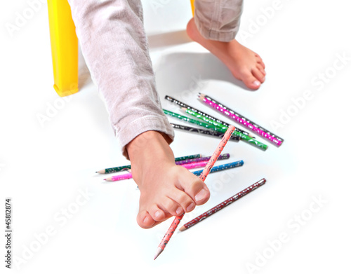 Photo: Child's feet performing gymnastic with pencils Child's feet performing gymnastic with pencils