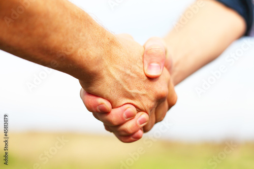 Photo: Closeup of people shaking hands Closeup of people shaking hands