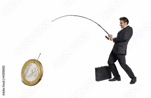 Photo: Ejecutivo atrapando,pescando un euro,concepto de negocios. Ejecutivo atrapando,pescando un euro,concepto de negocios.
