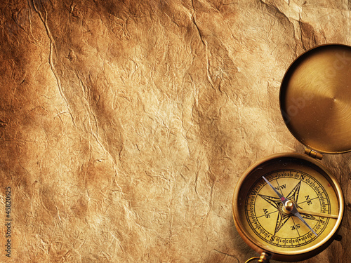 Photo: Compass on vintage paper Compass on vintage paper