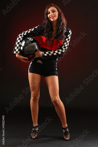 Photo: young happy girl in a racing suit young happy girl in a racing suit