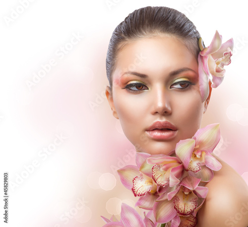 Fototapeta Beautiful Girl With Orchid Flowers. Perfect Make-up