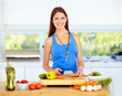 Cropped view of a woman's hands chopping vegetables 