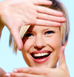 Portrait of a pretty young woman making a frame with her hands