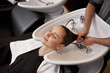 A woman having her hair washed in a hairdressers, close up