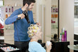 Photo: A male hairdresser drying a female clients hair A male hairdresser drying a female clients hair