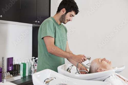 Photo: A male hairdresser washing a female clients hair A male hairdresser washing a female clients hair