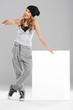 Female modern dancer holding white empty board