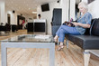 A senior woman reading a magazine at a hairdressers