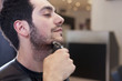 Photo: A male client having his facial hair trimmed, close up A male client having his facial hair trimmed, close up
