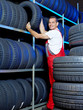 Car mechanic stores winter tire in a warehouse for tires
