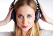 Foto: nice blond woman listening to the music on headphones nice blond woman listening to the music on headphones