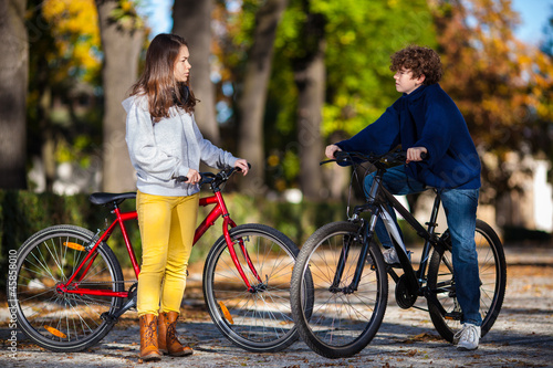 Photo: Urban biking - teens riding bikes in city Urban biking - teens riding bikes in city