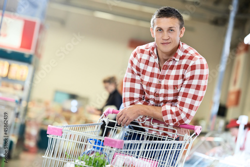 Photo: man at supermarket dairy shopping man at supermarket dairy shopping