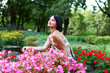 Beautiful girl in park with colorful flowers