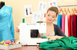 beautiful young dressmaker in workroom