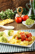 Noodles with broccoli, bacon and tomato