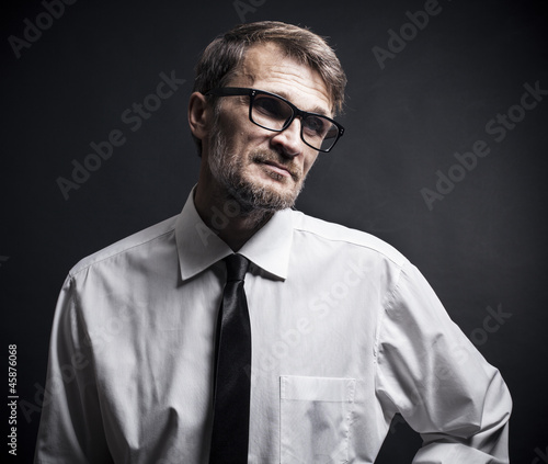 Photo: portrait of a man with a beard wearing glasses portrait of a man with a beard wearing glasses