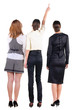 Back view of three beautiful young bussineswoman looking