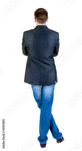 Photo: Back view of young expert looks ahead. Back view of young expert looks ahead.