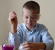 child is doing experiments in chemistry