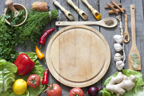 Photo: Vegetables and spices vintage border and empty cutting board Vegetables and spices vintage border and empty cutting board