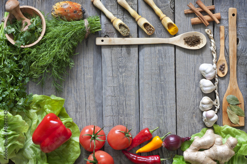 Photo: Vegetables and spices vintage border and empty cutting board Vegetables and spices vintage border and empty cutting board