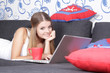 Photo: young happy smiling woman with laptop working at home young happy smiling woman with laptop working at home