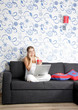 Photo: young happy smiling woman with laptop working at home young happy smiling woman with laptop working at home